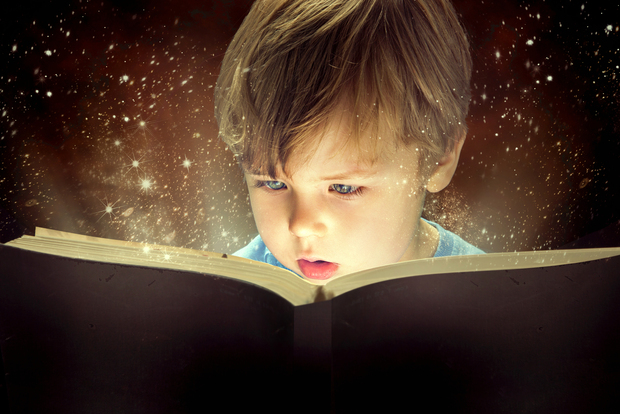 Boy opening a book. Boy opening a book.