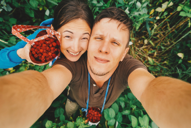 Happy couple with raspberries Happy couple with raspberries