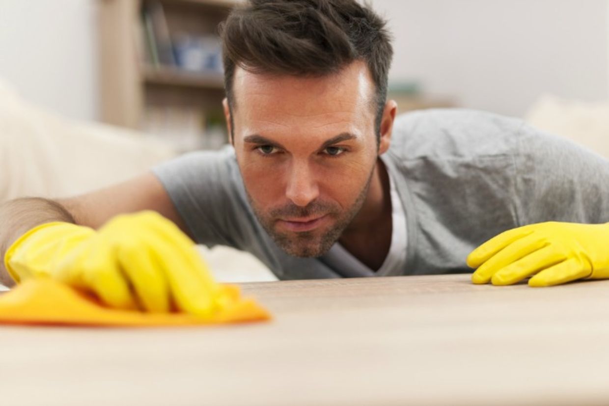 Man focusing on spring cleaning Man focusing on spring cleaning