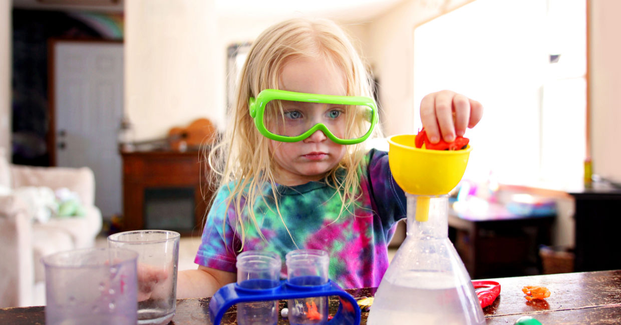 A little girl playing with a science toy. A little girl playing with a science toy.