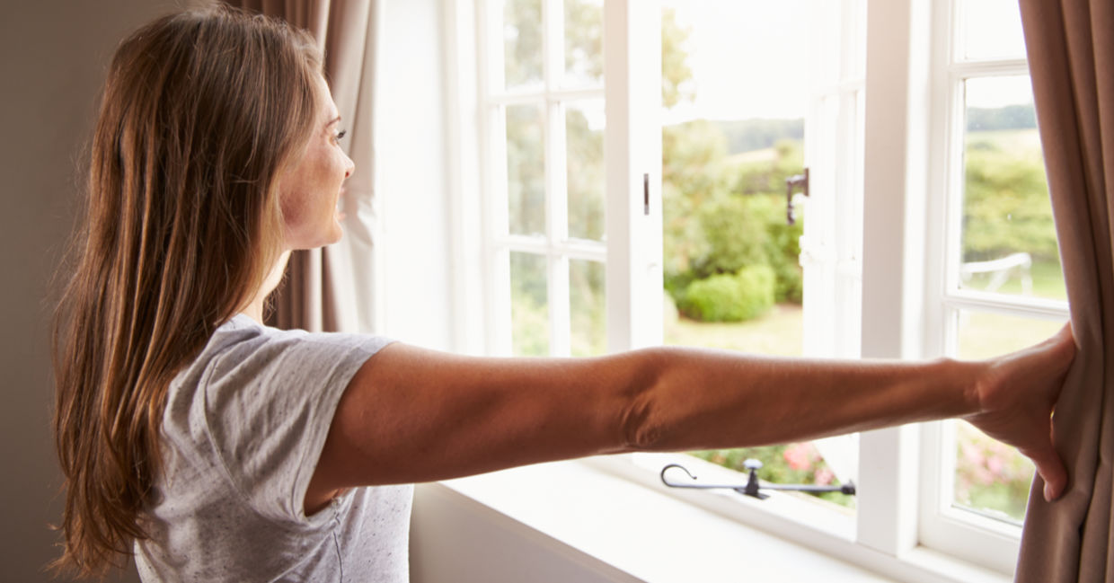Woman thinking about her goals by a window Woman thinking about her goals by a window