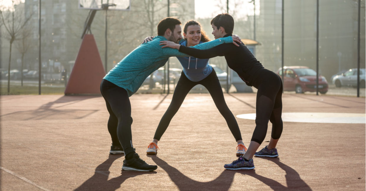 Three fitness friends huddle. Three fitness friends huddle.