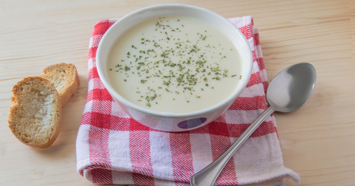 A bowl of vichyssoise served with sliced baguette. A bowl of vichyssoise served with sliced baguette.