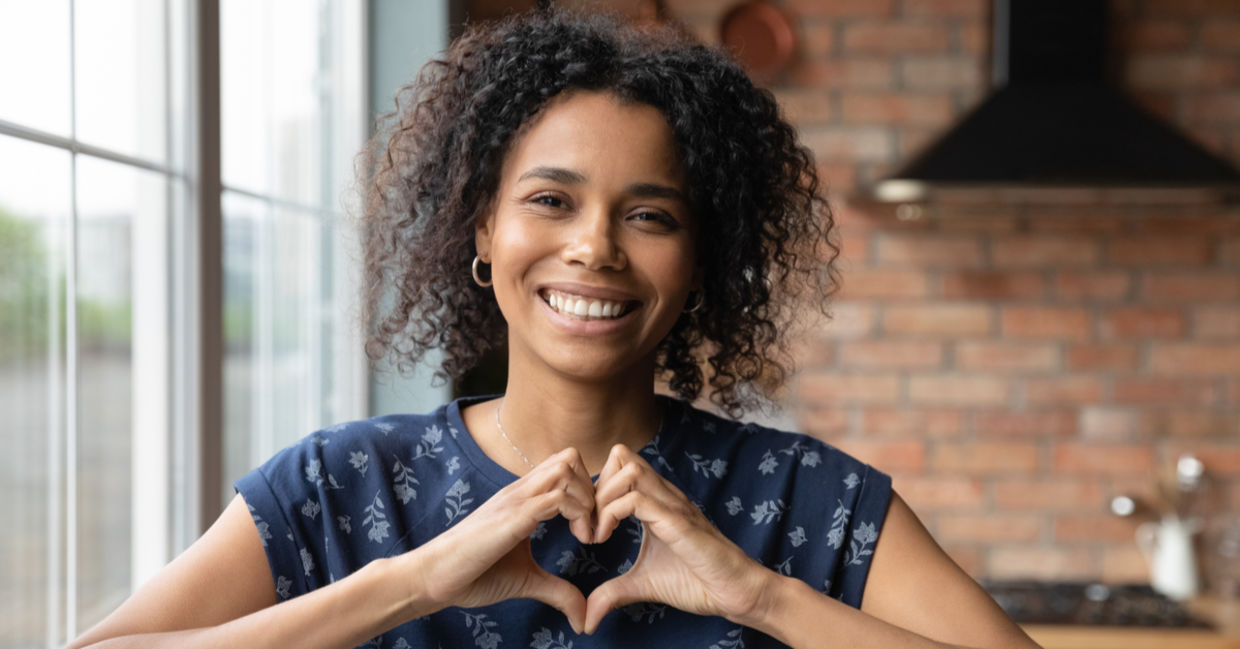 Portrait of kind student showing heart symbol with her hands Portrait of kind student showing heart symbol with her hands