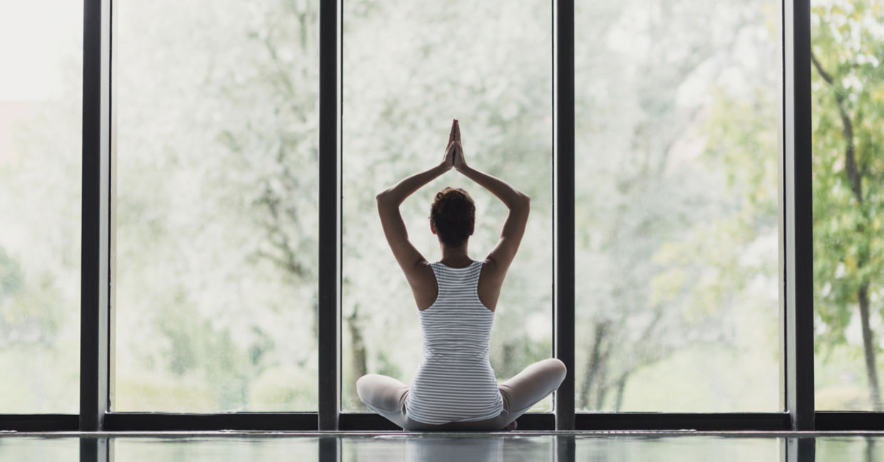 Young woman meditating at home. Young woman meditating at home.
