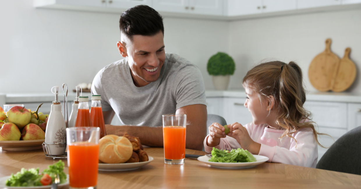 Father and daughter enjoying a healthy breakfast together. Father and daughter enjoying a healthy breakfast together.