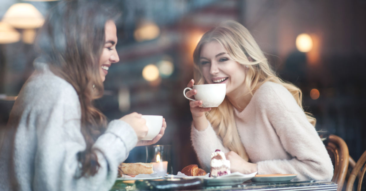 Two girlfriends connect over coffee for a gezellig day at a cafe. Two girlfriends connect over coffee for a gezellig day at a cafe.