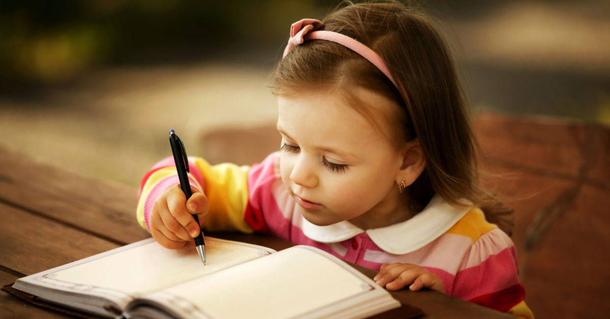 A little girl learning to write. A little girl learning to write.