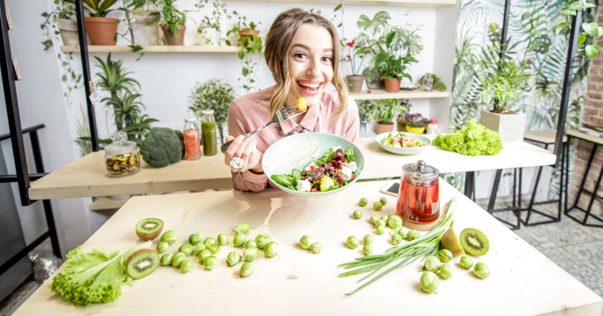 A woman eats healthy food including brussels sprouts. A woman eats healthy food including brussels sprouts.