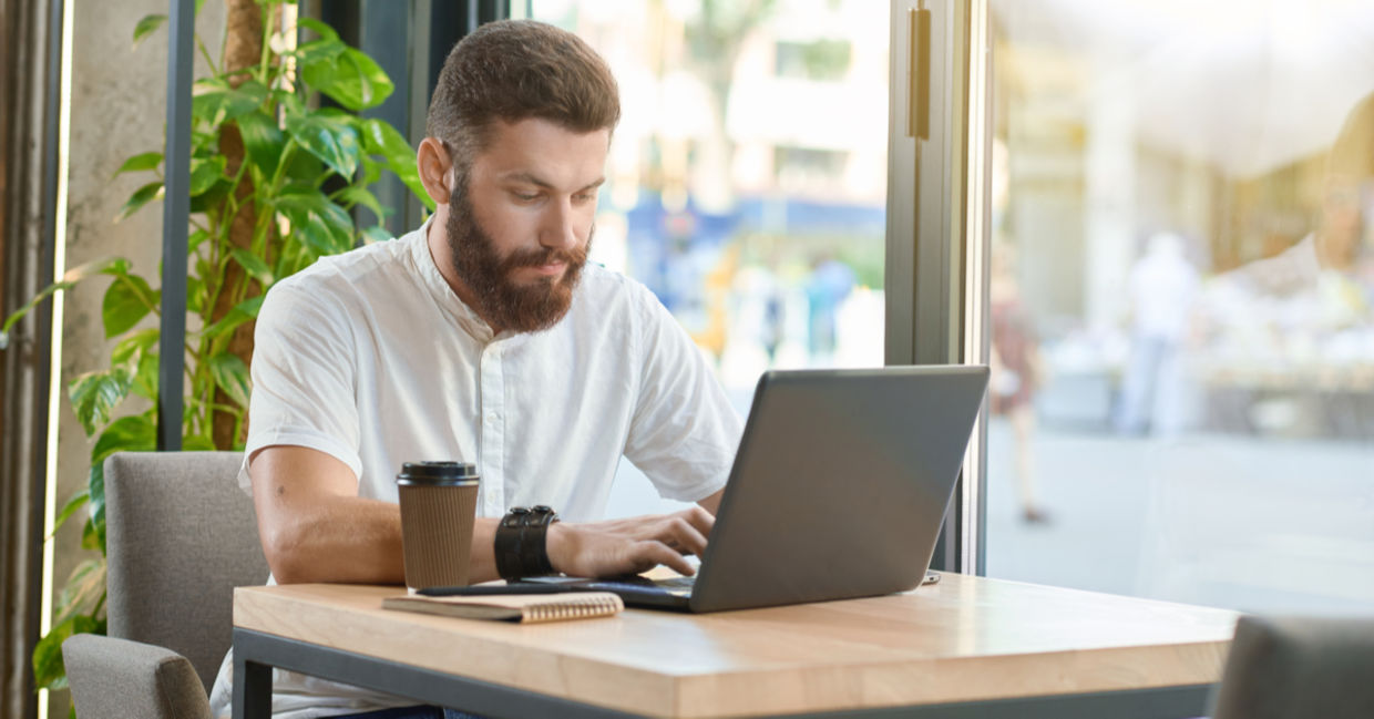 A man works with a laptop. A man works with a laptop.