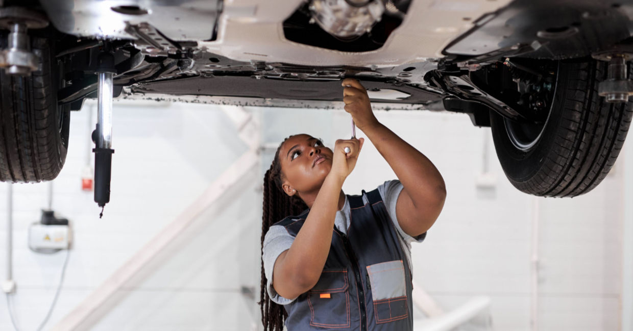 A female car mechanic at work. A female car mechanic at work.