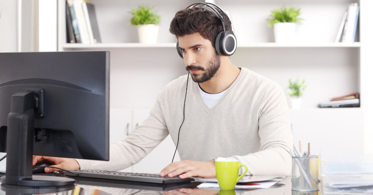 A young man sitting with headphones. A young man sitting with headphones.