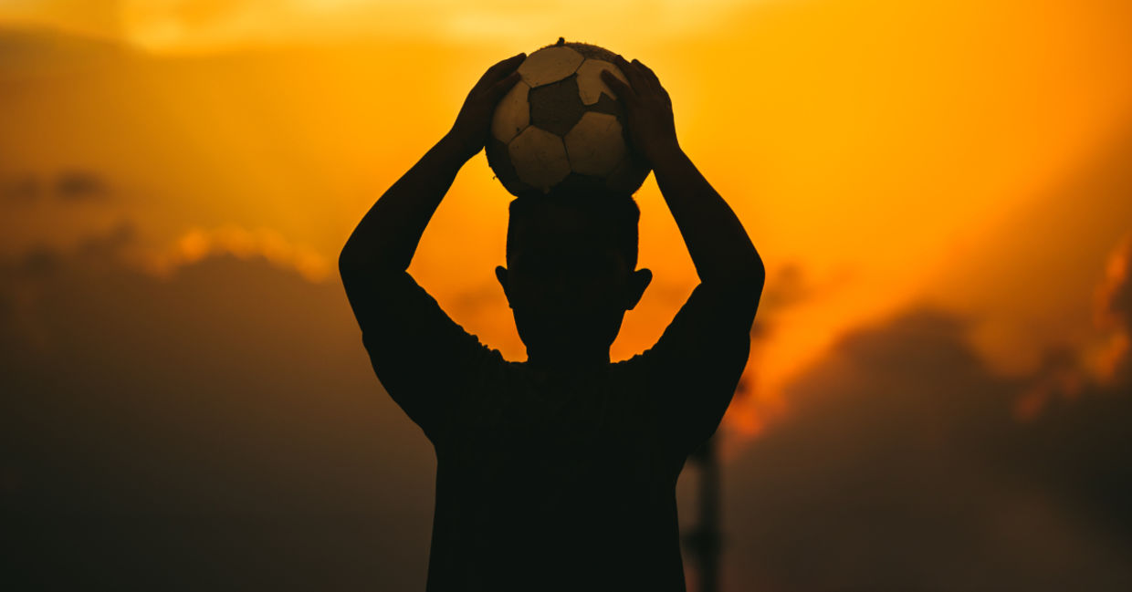 A child holding a soccer ball. A child holding a soccer ball.