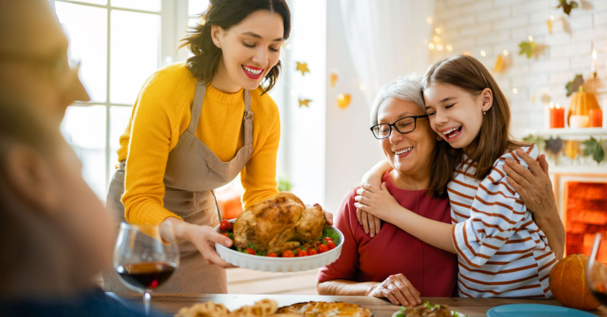 A family is seated around the table for a traditional Thanksgiving dinner. A family is seated around the table for a traditional Thanksgiving dinner.