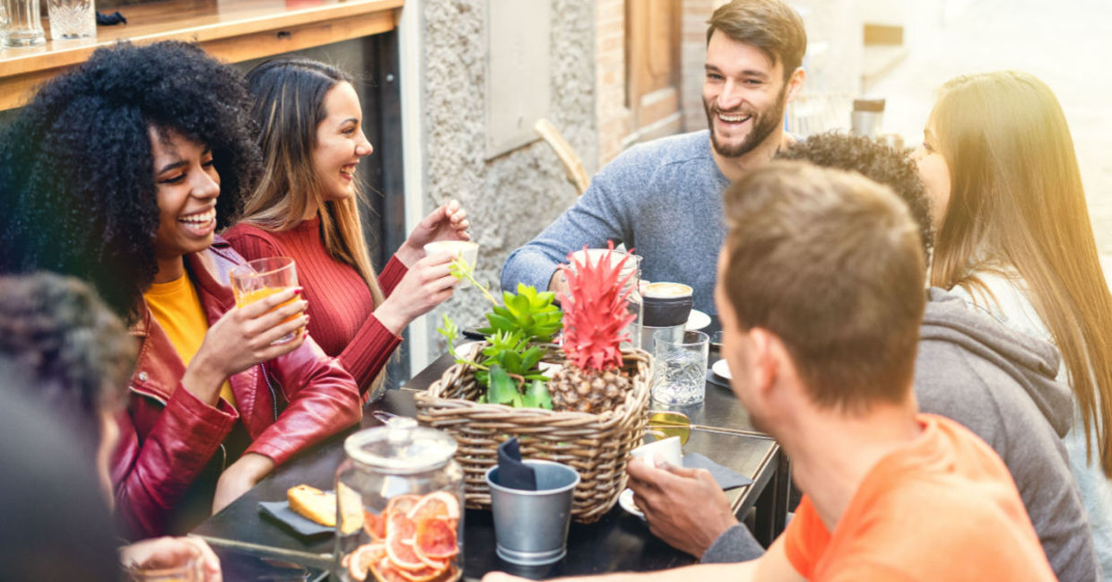 A group of friends enjoying a meal together at a restaurant. A group of friends enjoying a meal together at a restaurant.