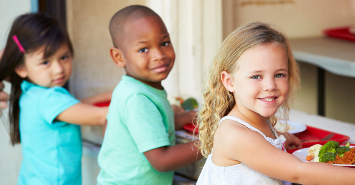 Elementary pupils collect healthy school lunches in the cafeteria. Elementary pupils collect healthy school lunches in the cafeteria.