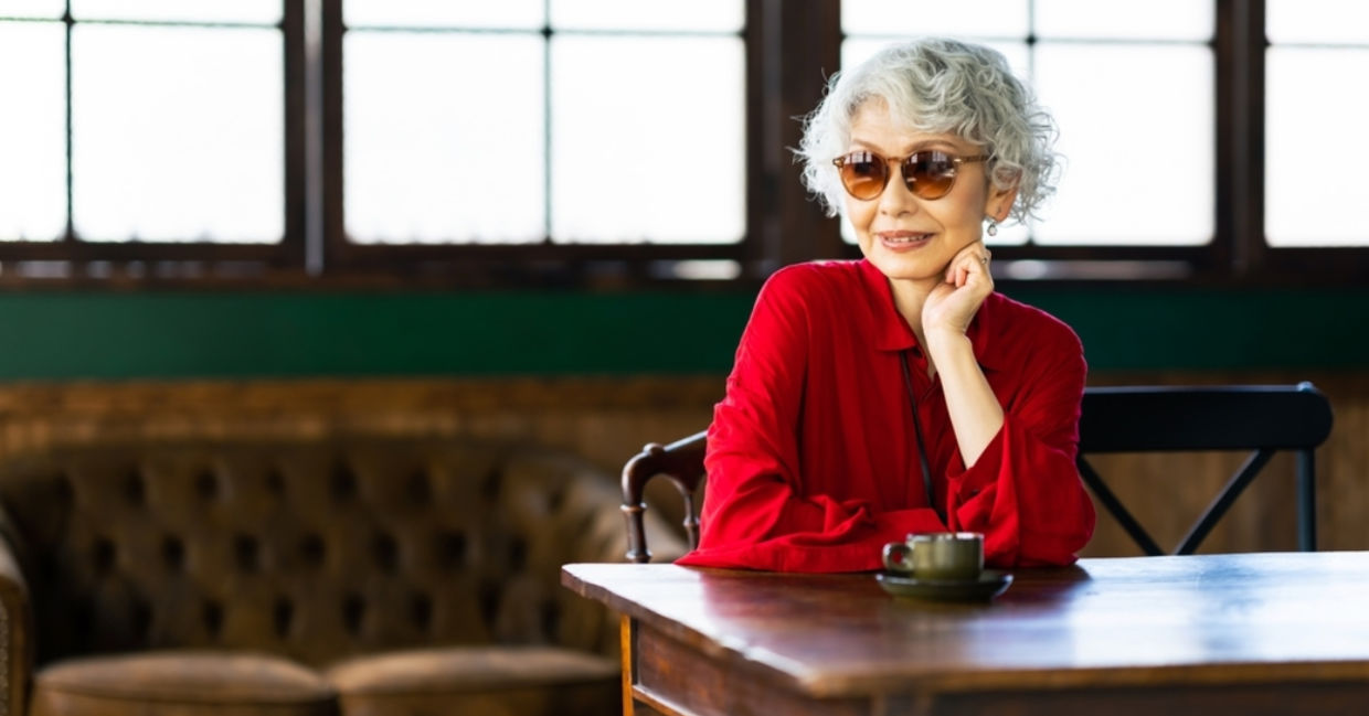 Senior Japanese woman relaxing in a restaurant. Senior Japanese woman relaxing in a restaurant.