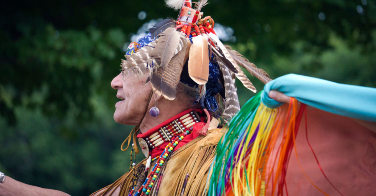 A Native American man from the Pokanoket Wampanoag tribe wearing traditional clothing at a local powwow in Haverhill, Massachusetts, USA. A Native American man from the Pokanoket Wampanoag tribe wearing traditional clothing at a local powwow in Haverhill, Massachusetts, USA.