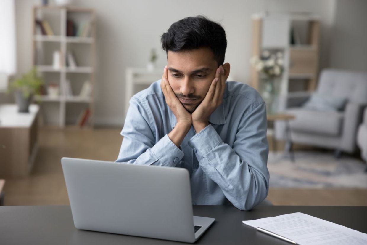 A man who is stuck in a procrastination cycle. A man who is stuck in a procrastination cycle.