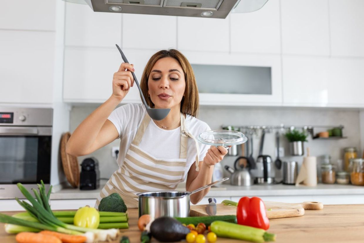 Woman cooking in a host kitchen. Woman cooking in a host kitchen.