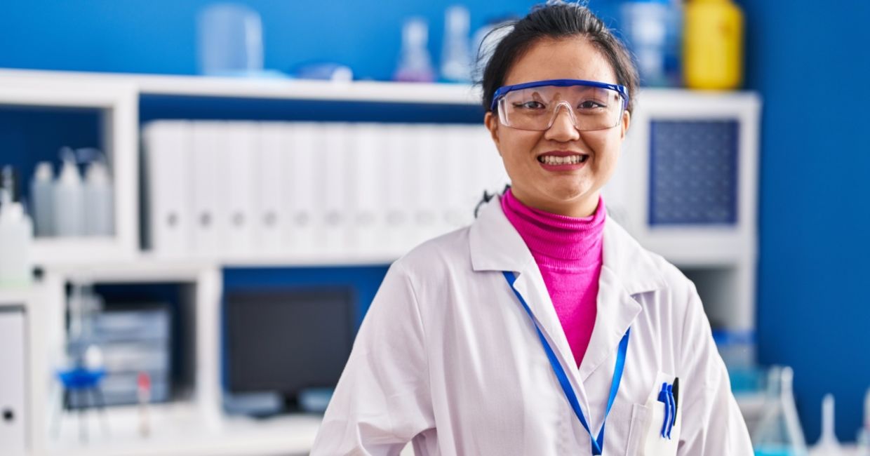 Young scientist in lab coat celebrating new research achievements. Young scientist in lab coat celebrating new research achievements.