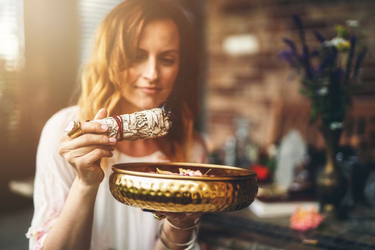 A woman smudging to cleanse her spirit. A woman smudging to cleanse her spirit.