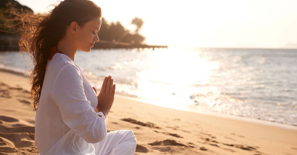 Practicing meditation on a beach. Practicing meditation on a beach.