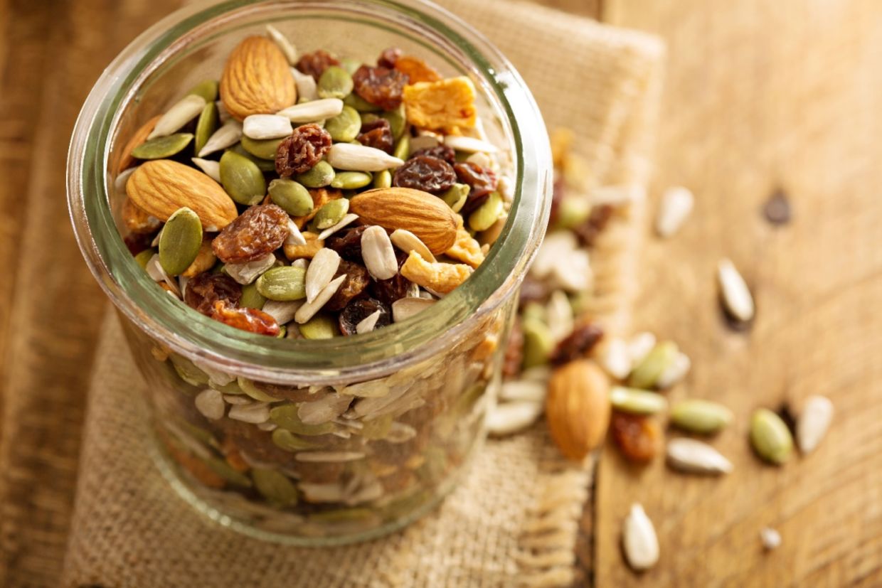 A jar filled with seeds and nuts. A jar filled with seeds and nuts.