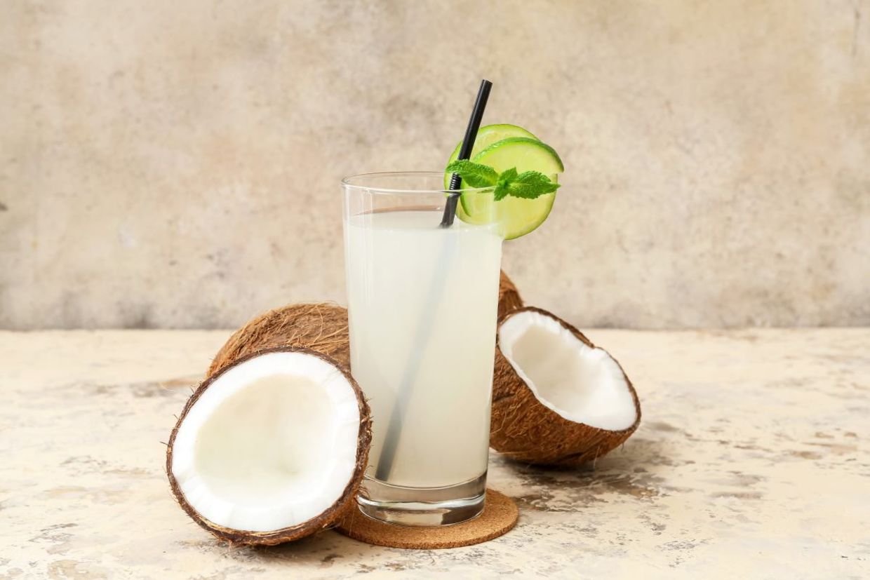 A glass of fresh coconut water. A glass of fresh coconut water.